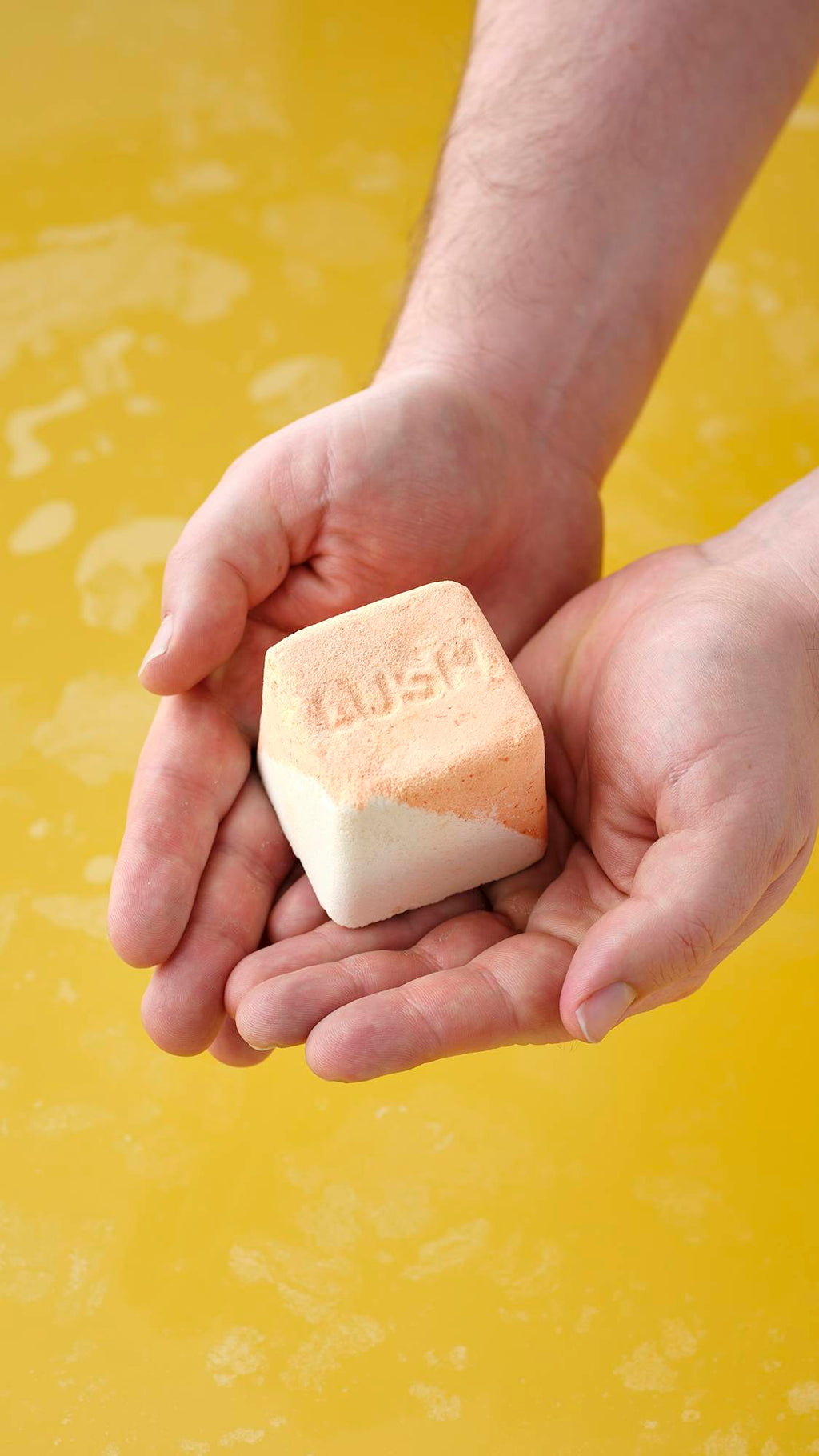 The Cold Water Soother bath bomb sits on a plain, light gray background. The spherical product is primarily a pale, icy blue with a marbled, textured surface featuring subtle white and yellow highlights.