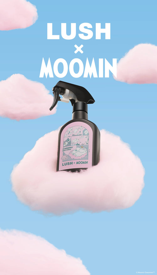 A promotional graphic featuring a black trigger spray bottle of Moomin body spray resting on a fluffy pink cloud. The sky-blue background is filled with scattered pink clouds below bold white text reading "LUSH x MOOMIN".