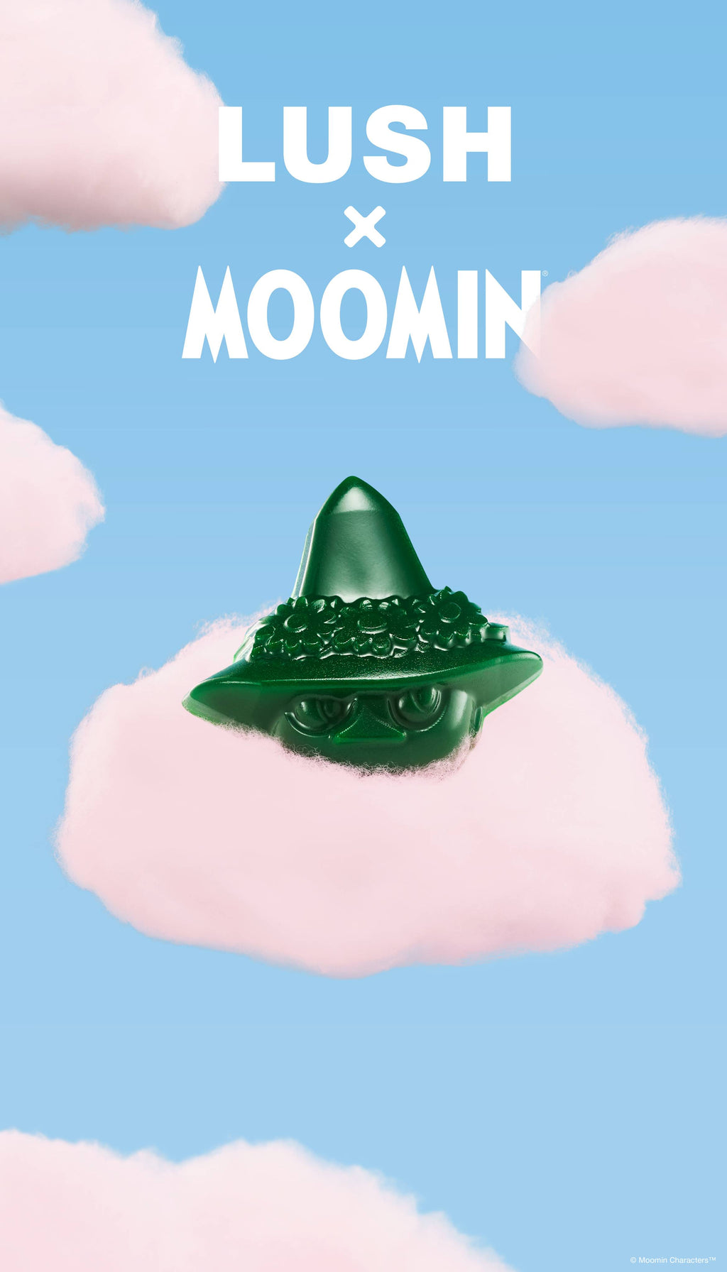 A promotional graphic featuring a green Snufkin-shaped soap bar resting on a fluffy pink cloud. The sky-blue background is filled with scattered pink clouds below bold white text reading "LUSH x MOOMIN".