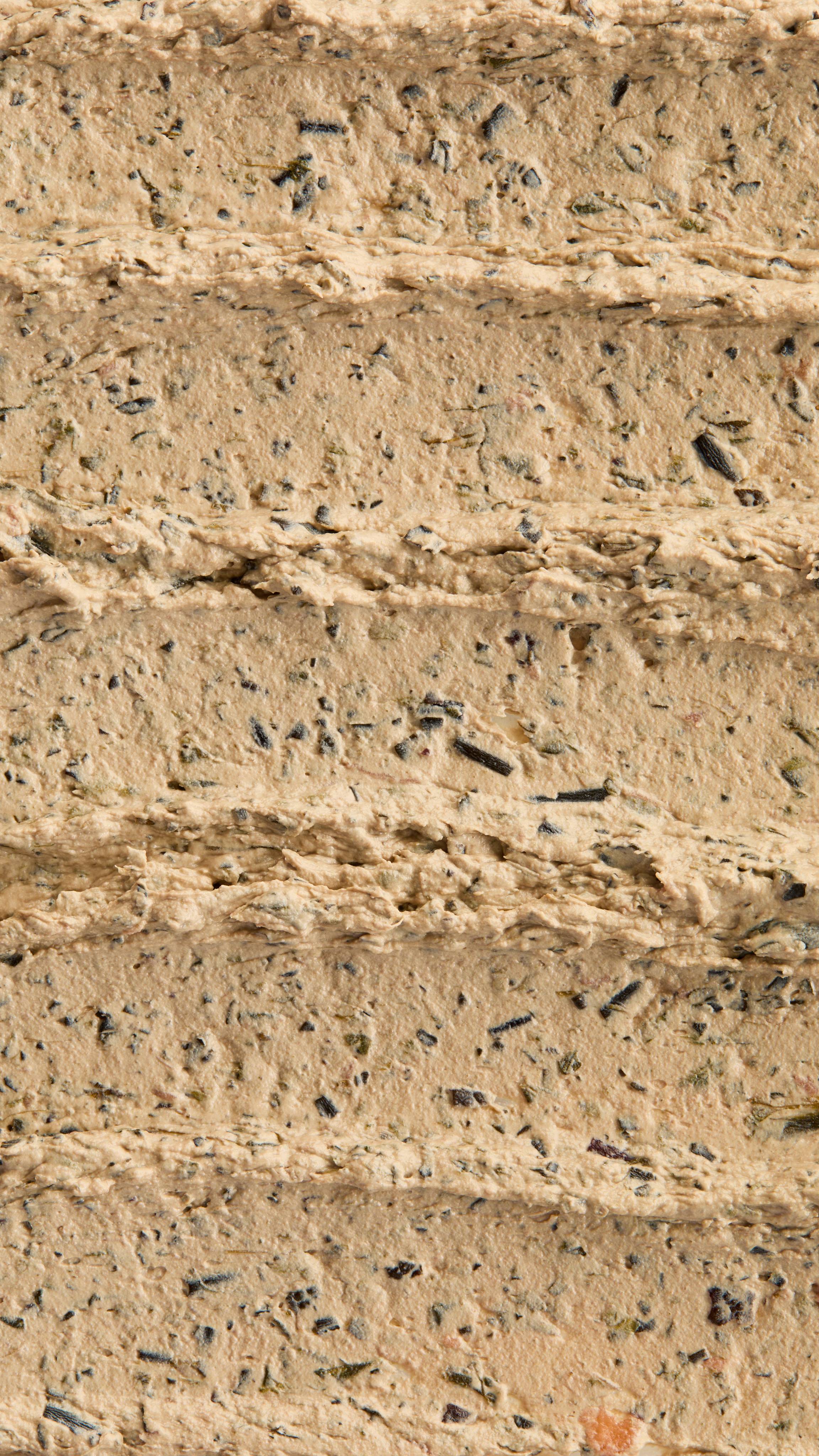 A super close-up image of the creamy, textured Mineralise Me face mask product, focusing on the thick consistency of the flecks of finely blended seaweed.