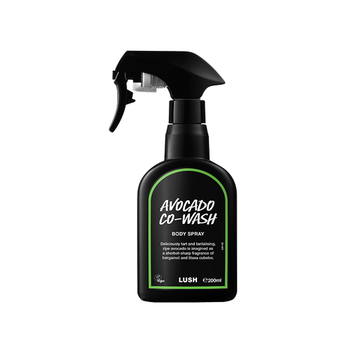 Avocado Co-Wash. A black spray bottle of Lush Avocado Co-Wash Body Spray. The product label is black with a lime green banded border. White text states the product name and the scent description.