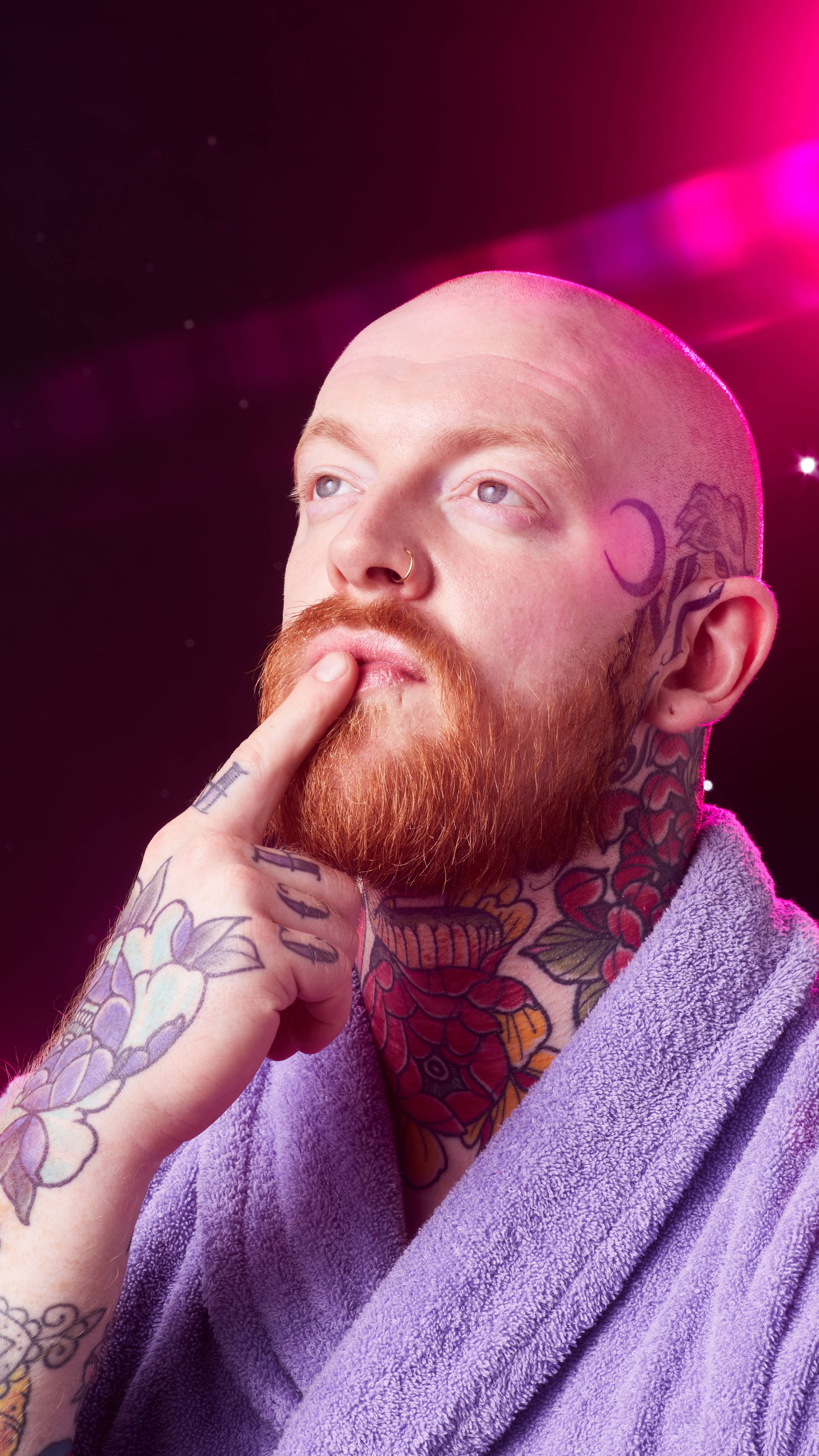 Image shows the model in front of a starry backdrop as they gently apply the Gingerbread lip scrub to their lips.