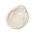 Karma Kream. A smooth, circular dollop of creamy, off-white Lush skincare product, showing soft ridges and a rich, glossy texture.