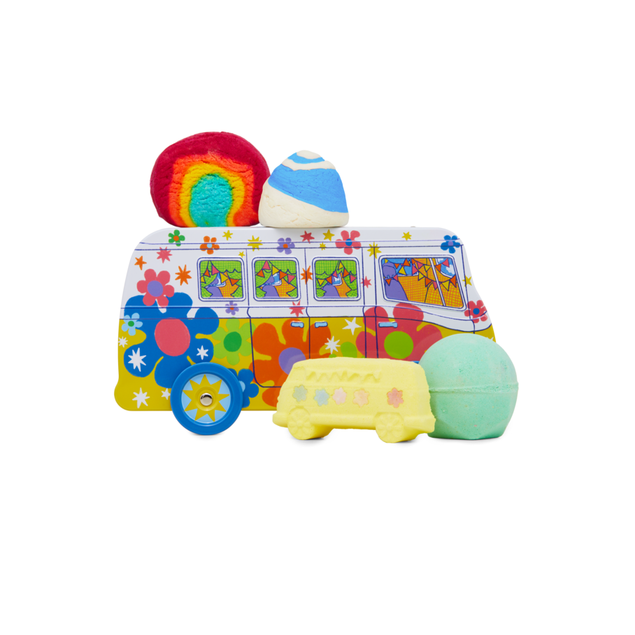 Magic Bus. A gift set featuring a psychedelic camper van tin product holder with wheels. Four Lush bathing products sit around it, including two bubble bars and two bath bombs.