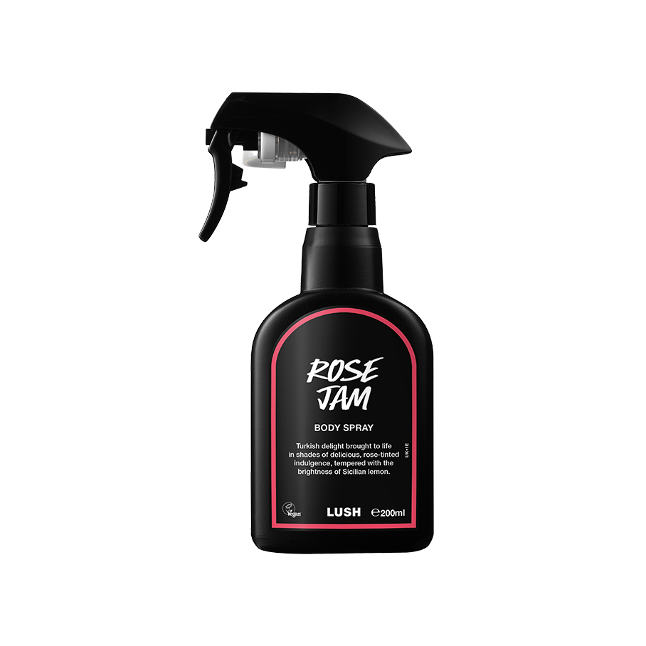 Rose Jam body spray. A black spray bottle of Lush "Rose Jam" Body Spray. The product label is black with a rose-pink banded border. White text states the product name and the scent description.