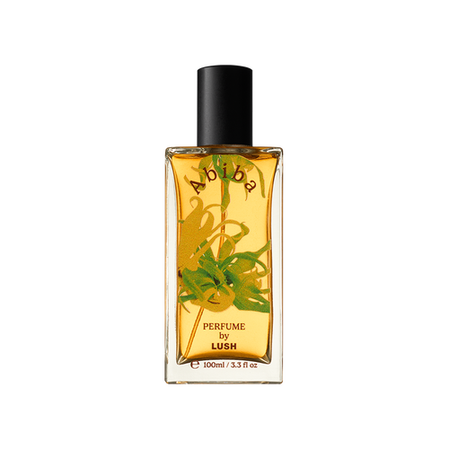 Abiba. A rectangular, glass perfume bottle with a black cap is filled with translucent, almost-yellow liquid. The name "Abiba" is arched on the front of the bottle along with flower decals.