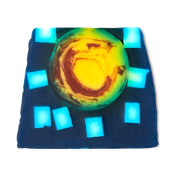 Alban Arthan. A colourful, thick soap slice with a deep, ocean-blue base with large square flecks of off-white. In the centre is a large, yellow circle with warm red swirls.