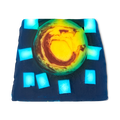 Alban Arthan. A colourful, thick soap slice with a deep, ocean-blue base with large square flecks of off-white. In the centre is a large, yellow circle with warm red swirls.