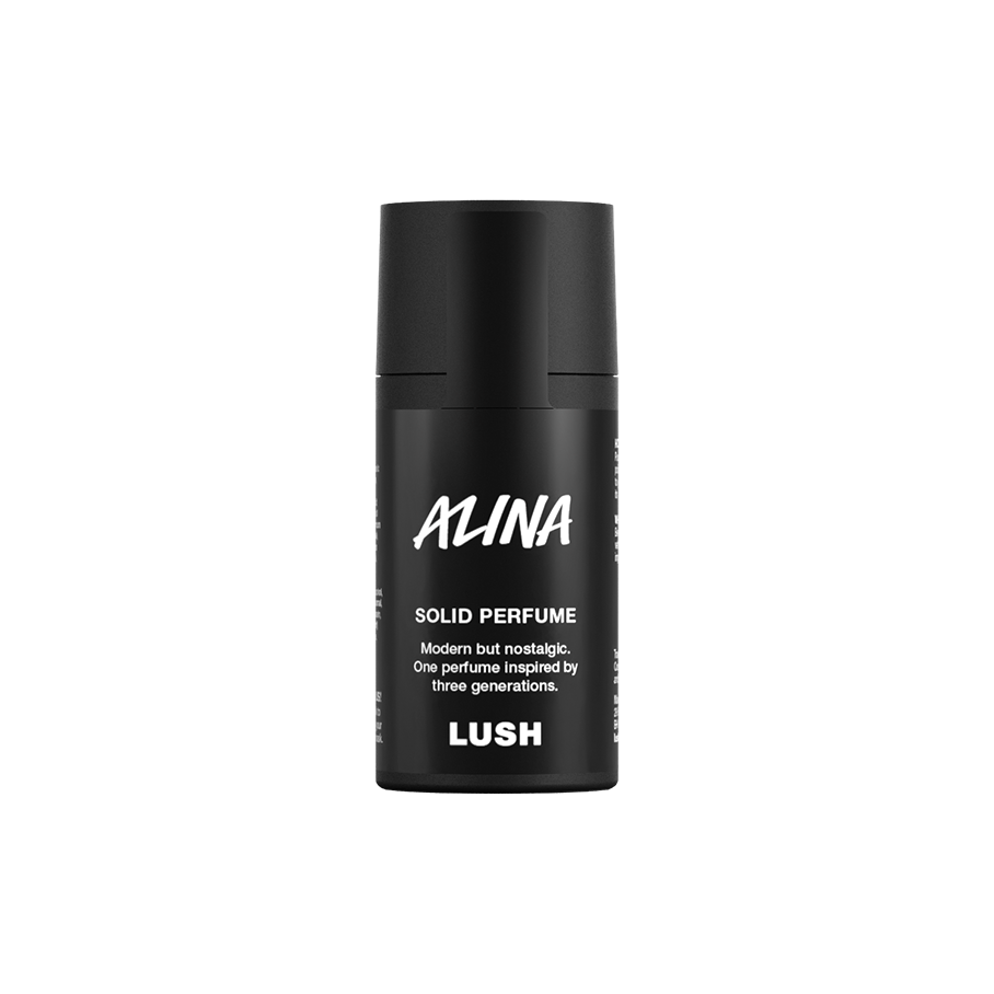 Alina. A short, cylindrical black push-up tube of the Alina solid perfume with a black label on the front covering the cap, with the product name and scent printed on it.