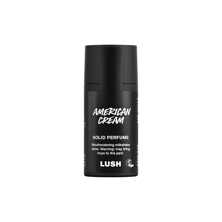 American Cream. A short, cylindrical black push-up tube of the American Cream solid perfume with a black label on the front covering the cap, with the product name and scent printed on it.