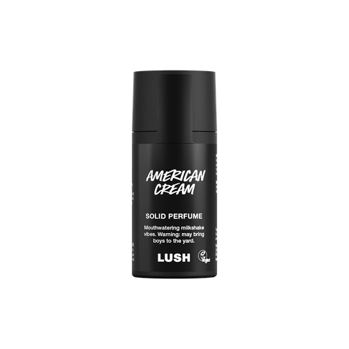 American Cream. A short, cylindrical black push-up tube of the American Cream solid perfume with a black label on the front covering the cap, with the product name and scent printed on it.