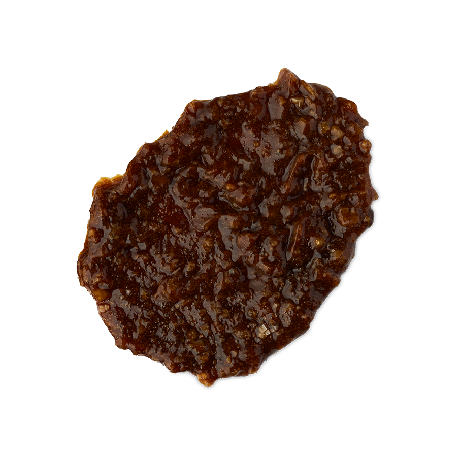 Banana. A smudged swatch of thick, textured shampoo. It is a rich hazelnut-brown colour with an almost treacle-like consistency and a lot of texture.