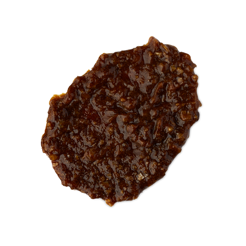 Banana. A smudged swatch of thick, textured shampoo. It is a rich hazelnut-brown colour with an almost treacle-like consistency and a lot of texture.