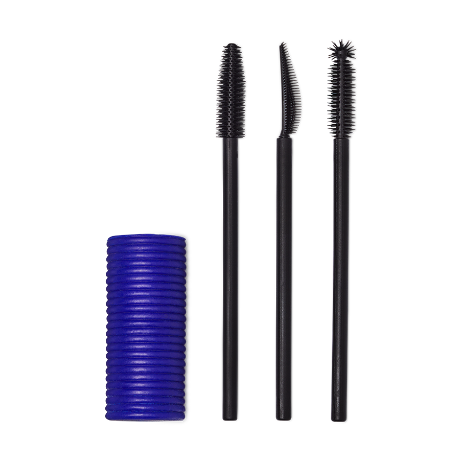 A Solid cylindrical block of blue mascara next to three different style mascara spoolie brushes.