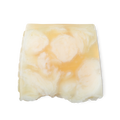 Bohemian. A light yellow, creamy swirled, smooth, trapezium shaped soap, with bumps along its left side.