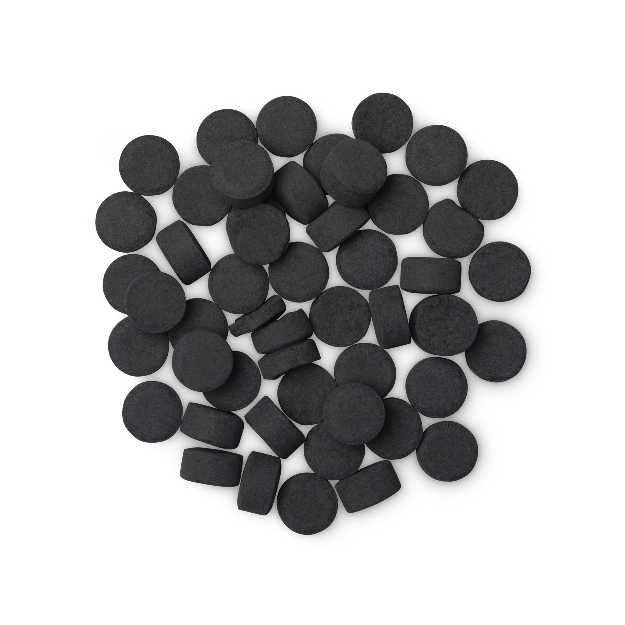 A pile of small, circular, black Boom! toothpaste tabs shot from above.