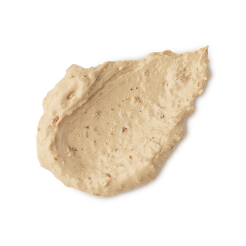 Bring Us Some Figgy Pudding. A neatly smudged swatch of thick, creamy, textured face mask. There are flecks of finely ground dried figs throughout the product.