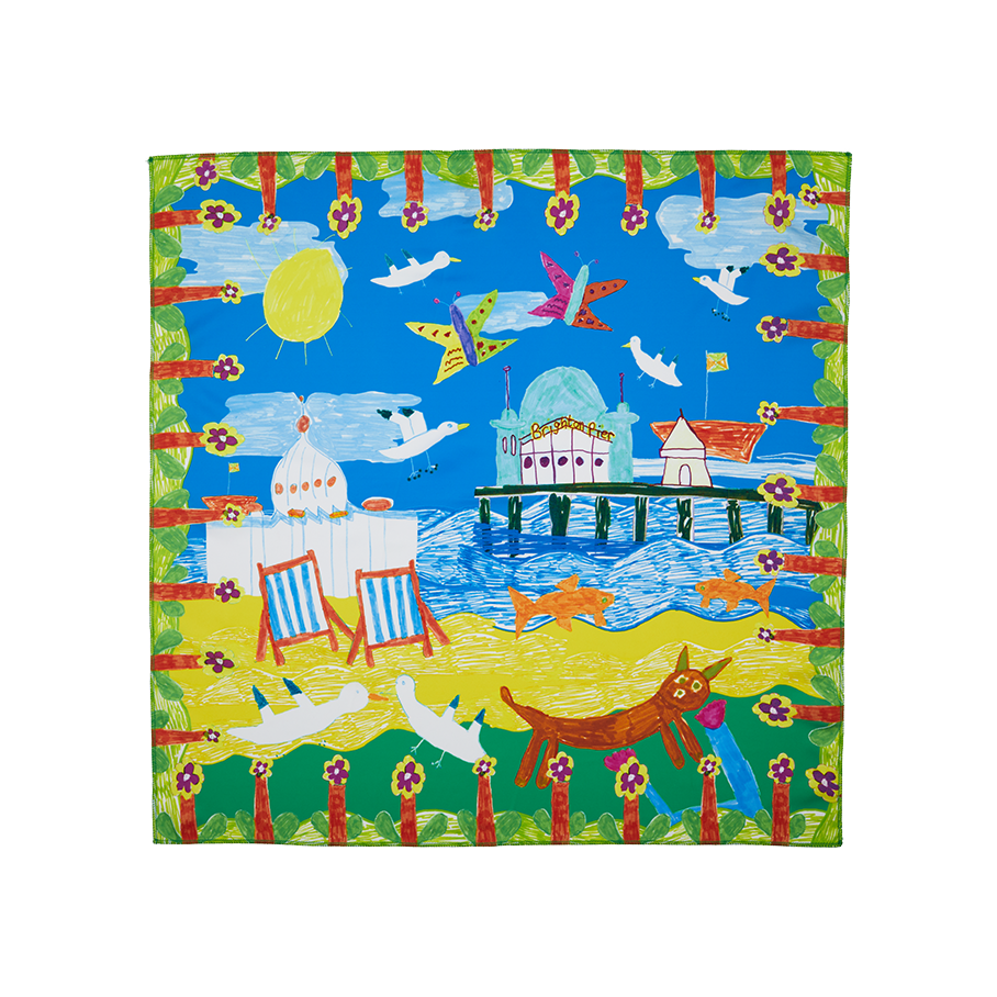 By The Seaside. A square knot wrap with a drawn, floral border depicting a sunny beach day complete with Brighton Pier, blue skies, deck chairs and seagulls.