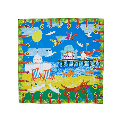 By The Seaside. A square knot wrap with a drawn, floral border depicting a sunny beach day complete with Brighton Pier, blue skies, deck chairs and seagulls.