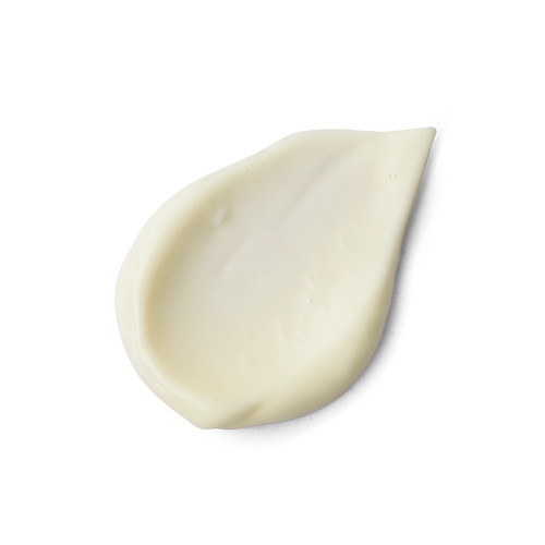 A close-up product swatch of a thick, teardrop-shaped dollop of Calm primer. The product has a creamy, smooth texture and a pale, yellowish-ivory color,
