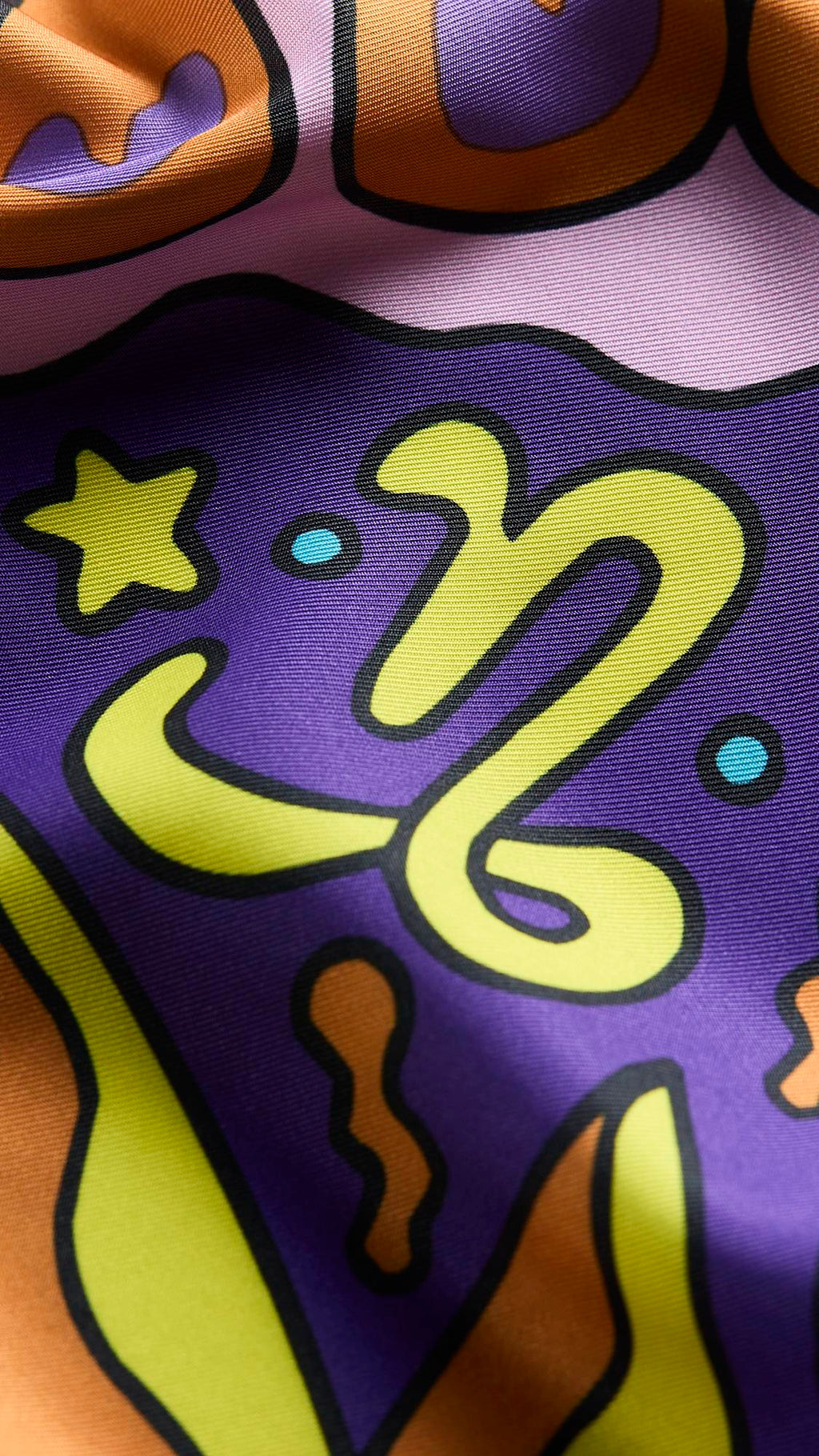 A super close-up image of the zodiac-themed Capricorn knot wrap. The image focuses on the detail of the product material and the vibrancy of the colours.