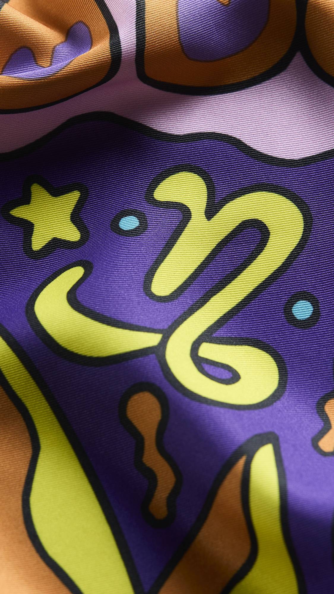 A super close-up image of the zodiac-themed Capricorn knot wrap. The image focuses on the detail of the product material and the vibrancy of the colours.