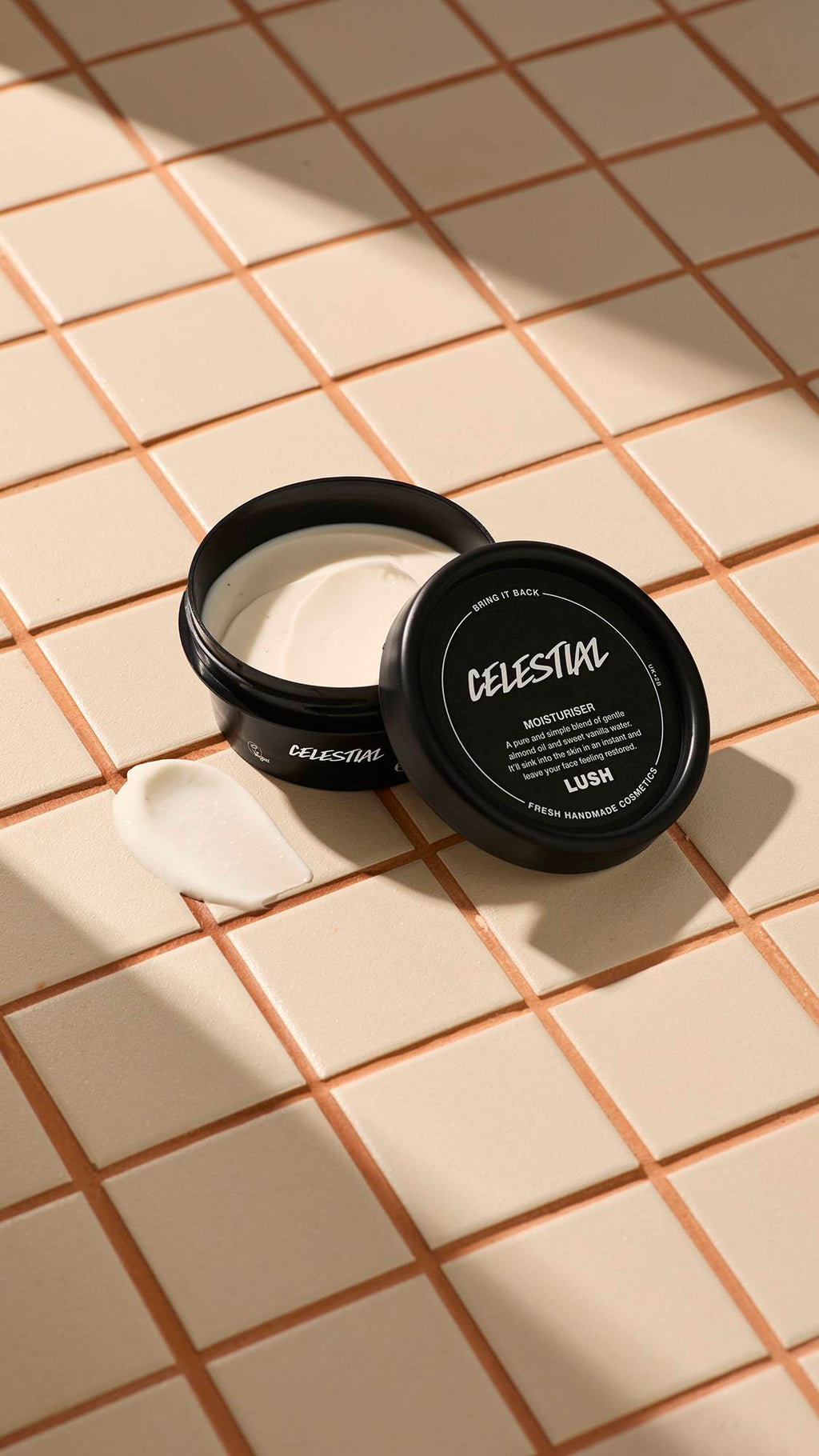A vertical, extreme close-up of thick, white cream, likely the Celestial Moisturiser, showing several smooth, diagonal, wavelike ridges of product with subtle shadows.