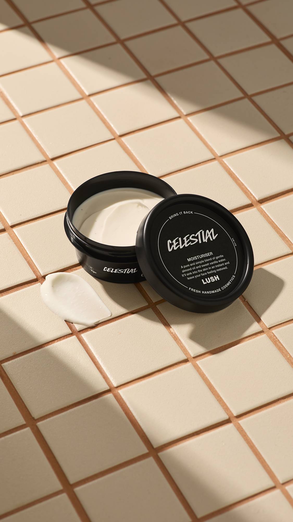 A vertical, extreme close-up of thick, white cream, likely the Celestial Moisturiser, showing several smooth, diagonal, wavelike ridges of product with subtle shadows.