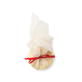Ceridwen's Cauldron Bath Melt. Wrapped in white muslin cloth and tied with a red ribbon is a cream coloured, round bath melt.