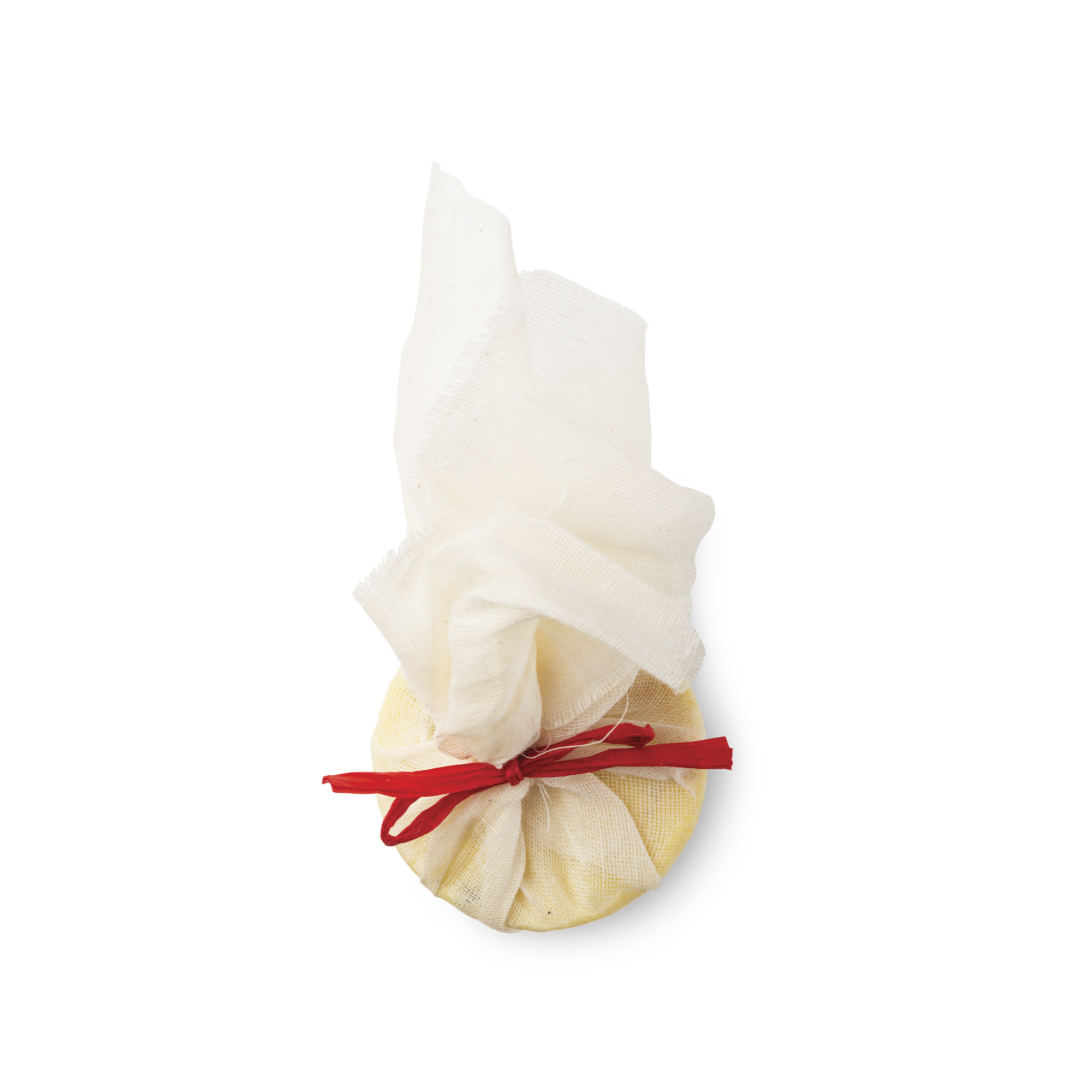 Ceridwen's Cauldron Bath Melt. Wrapped in white muslin cloth and tied with a red ribbon is a cream coloured, round bath melt.