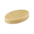 Coconut Drench. An oval, cream-coloured solid Lush massage bar with geometric and sunburst patterns embossed on top. The words 'MASSAGE BAR' are embossed along the curved side.
