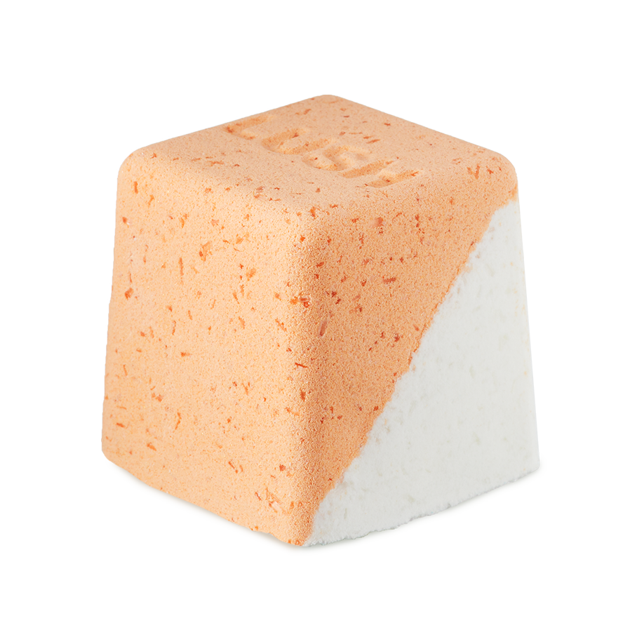 Cold Water Soother. A rounded, cube-shaped bath bomb with a lower diagonal half of crisp white and the top is a peachy-orange colour. There are visible flecks of Epsom salt throughout.