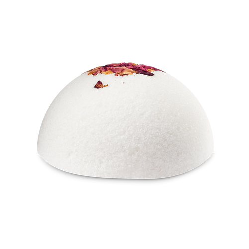 The Rose Comforter. A white, dome-shaped solid body scrub with a crystalline, salt-like texture. The top of the sphere is decorated with dried pink and yellow rose petals.