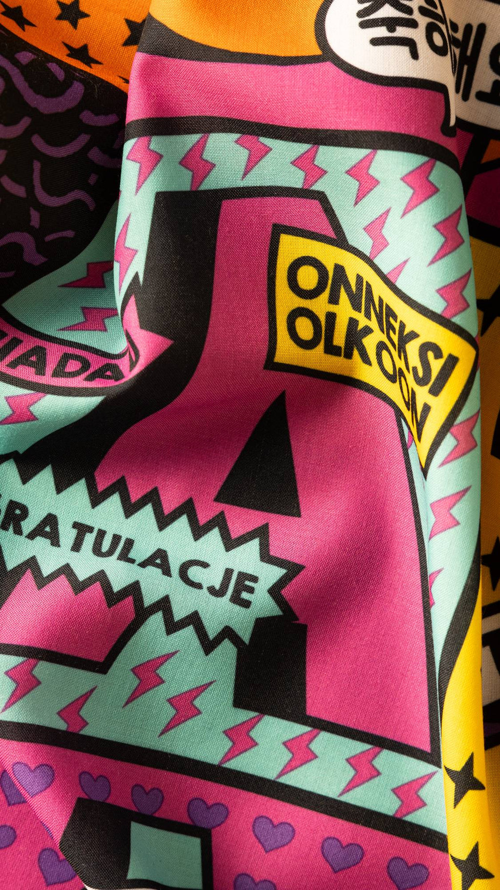 Image shows a super close-up of the Congratulations knot wrap. There is a large pink letter "A" surrounded by lightning bolts.