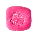 Creamy Candy bubble bar. A vibrant, hot pink rounded-square block, embossed with a flower on top.