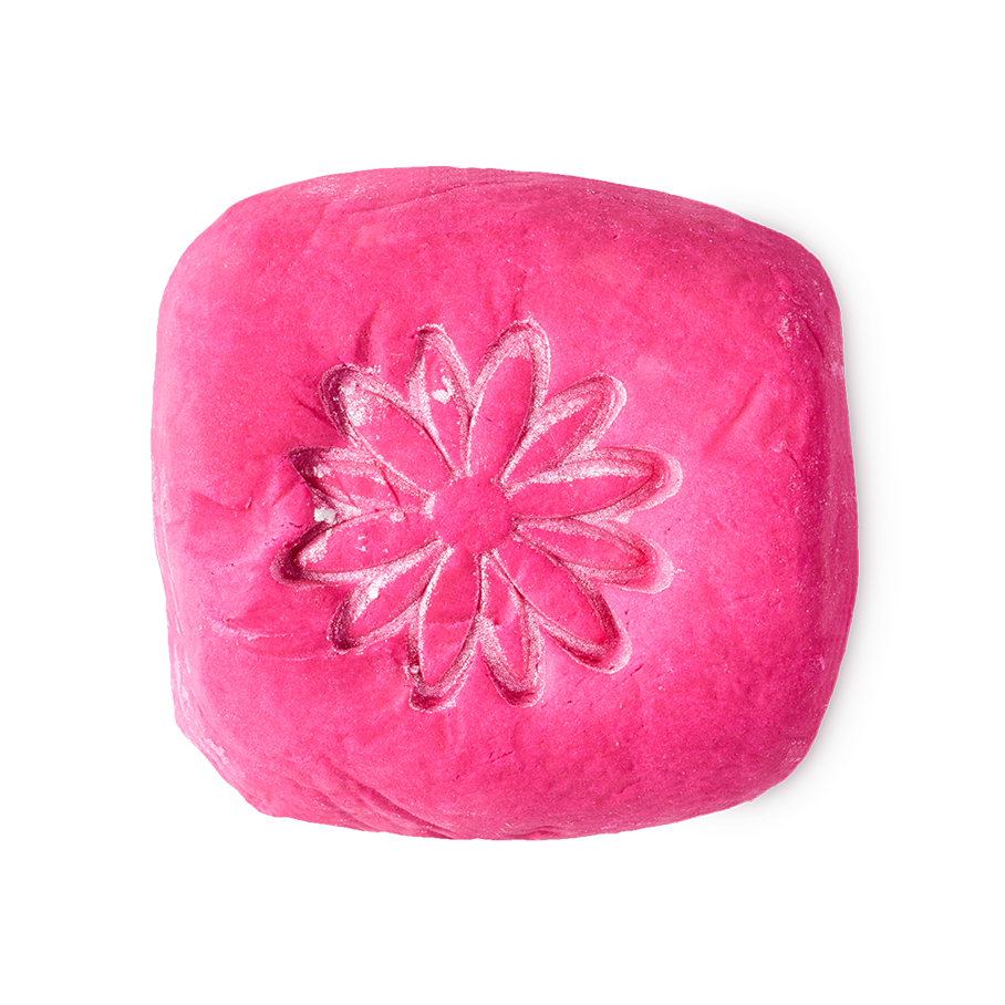 Creamy Candy bubble bar. A vibrant, hot pink rounded-square block, embossed with a flower on top.