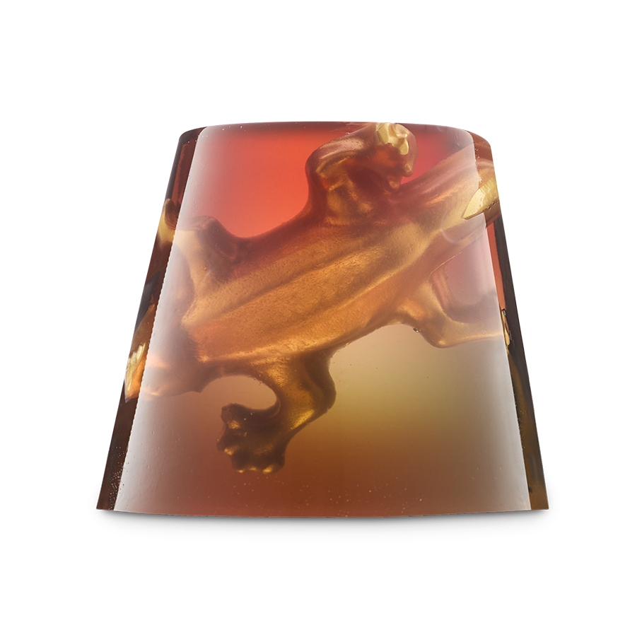 Creature Of The Night. A translucent, trapezoidal shower jelly. The jelly has an ombré gradient from deep red-orange at the top to a golden yellow at the bottom, with a 3D golden gummy lizard figure embedded inside.