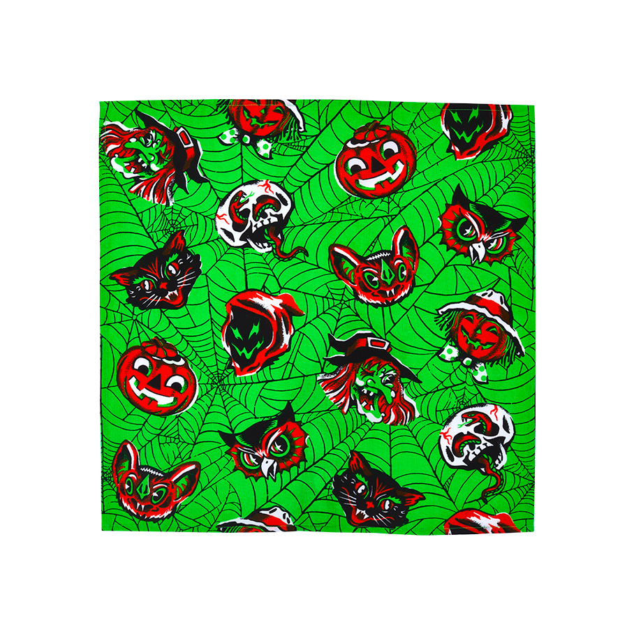 Creep It Real, Comrades. A square fabric wrap featuring a bright lime green cobweb pattern. It is decorated with a repeating vintage-style Halloween motif of red, black, and white pumpkins, witches, bats, owls, skulls, and black cats.