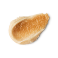 Crème Brûlée. A neatly smeared swatch of thick, ivory-coloured body scrub with a golden-brown textured topping product. The swatched cream has a glossy, slightly granular appearance with visible peaks and ridges.