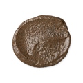 A swatch of Cup o' Coffee, a brown, creamy face and body mask, textured with ground coffee.