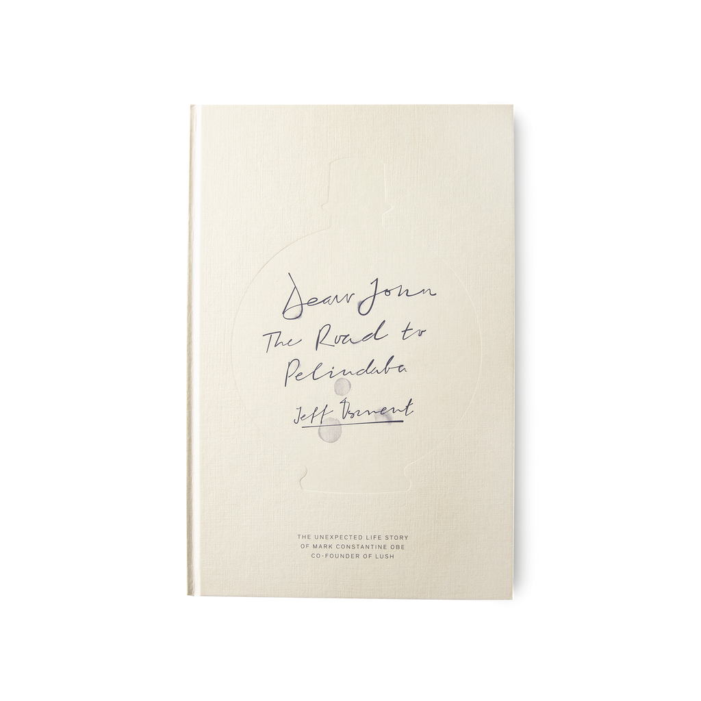 The book 'Dear John: The Road to Pelindaba', a cream coloured cover with the title printed in a handwritten font.
