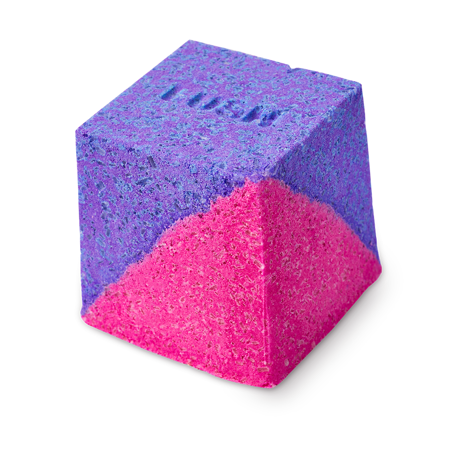 A cube-shaped Deep sleep Salt Cube bath bomb split diagonally into vibrant purple and neon pink. The purple top surface features the embossed "LUSH" logo.