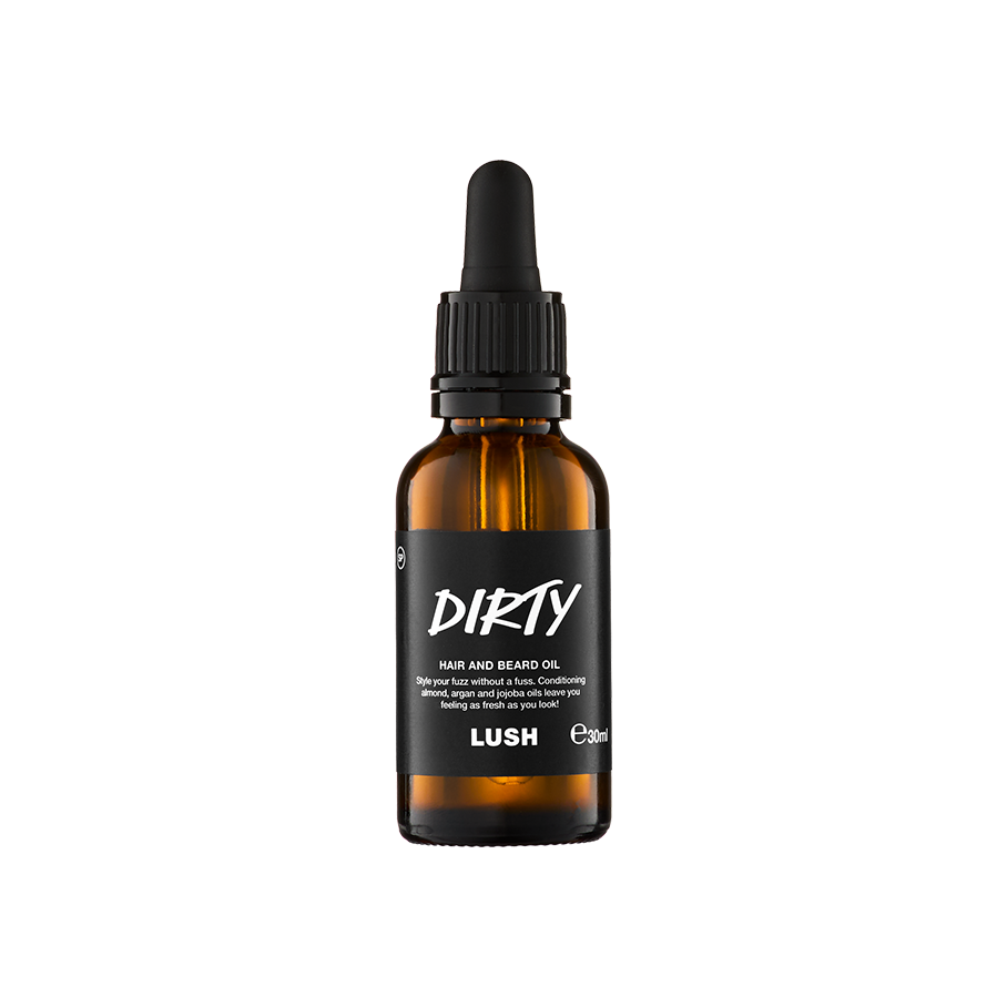 A small, amber glass bottle of "Dirty" hair and beard oil by Lush. The bottle features a black label with white text and a black pipette dropper lid, containing 30ml of product.