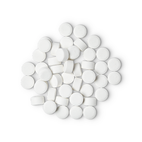 A pile of small, circular, white Dirty toothpaste tabs shot from above.