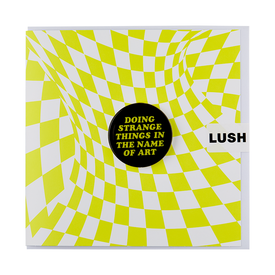 A Square greetings card with a warped white and neon green checkered design. A black badge sits in the centre with green text that reads "Doing Strange Things In The Name Of Art".