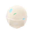 Dragon's Egg. A spherical, pale off-white bath bomb with a flat, geometric base. It has small, colourful spots of blue and green peeking through the surface.