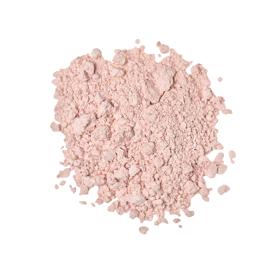 An overhead close-up view of a small pile of pale pink, finely milled powder that appears slightly chunky and matte, centered on a light grey background. The product is Emotional Brilliance ~ Finishing Powder.