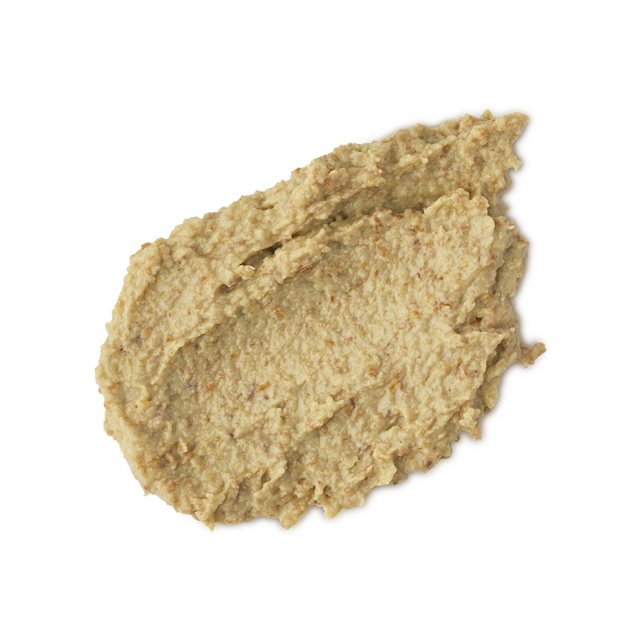 Enzynamite. A round, smudged swatch of pale, golden, creamy face mask with visible textured exfoliating pieces.