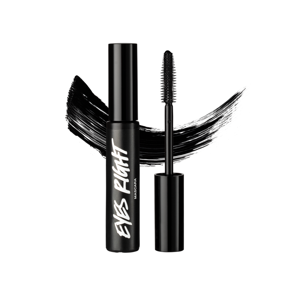 A tube and wand of Eyes Right mascara, both made of black Lush plastic, are positioned in front of a swatch of black mascara.