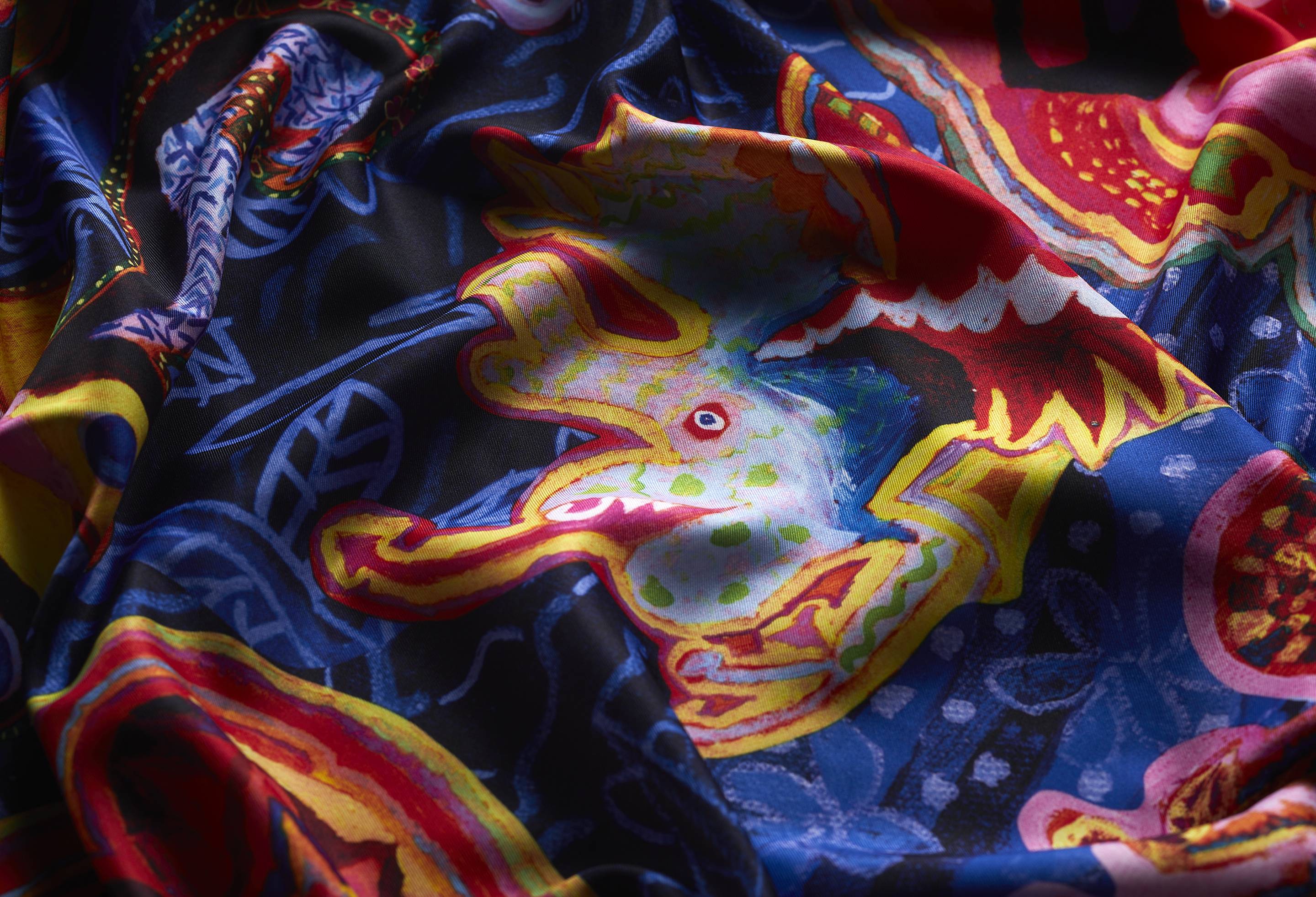 A close-up image of the Fantasy Animals knot wrap. The knot wrap is laid gently ruched, focusing on the detail of vivid colours and textures.